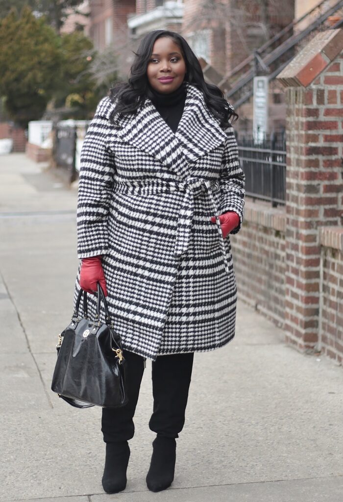 A Houndstooth Wrap Winter Coat And Red Leather Gloves