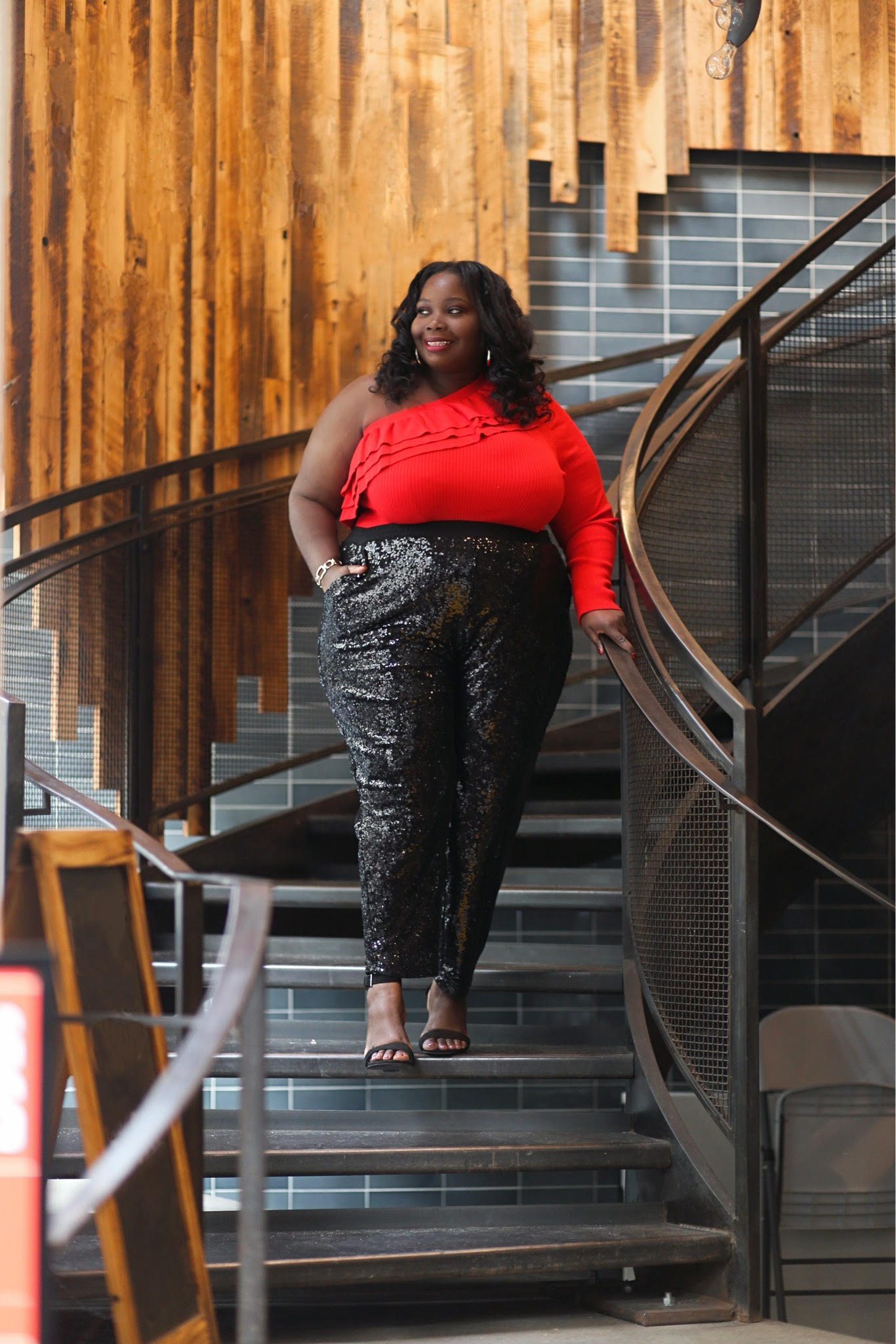 A dressy casual look featuring sequin pants and a one shoulder red ruffled top. 