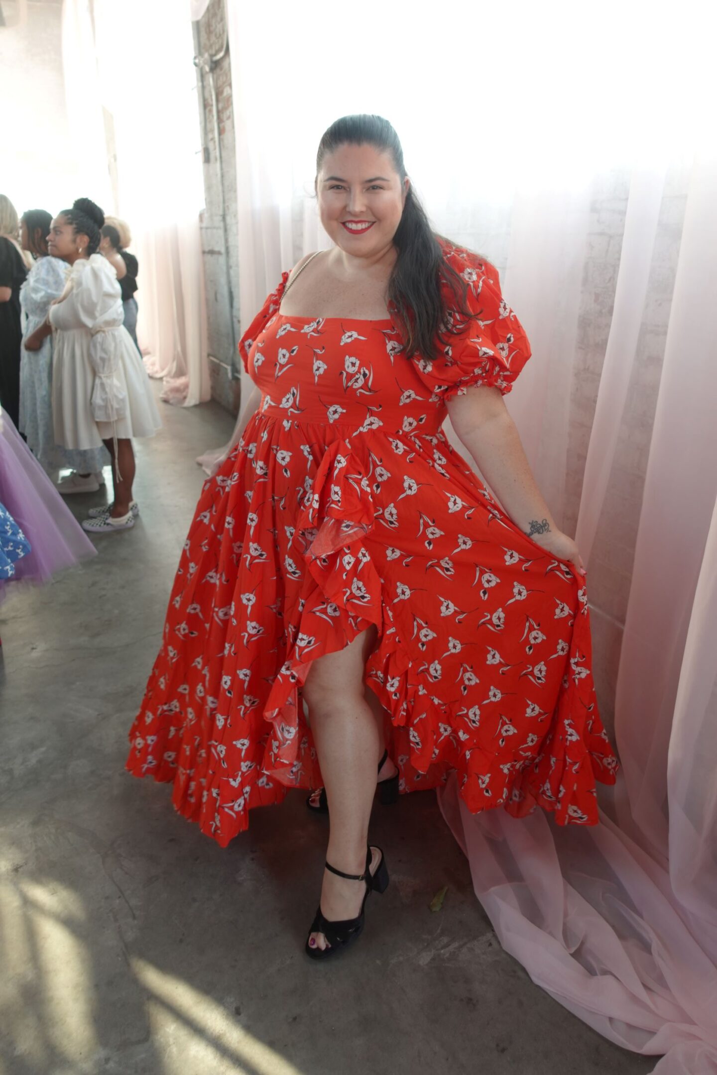 plus size women in a red floral printed ruffle dress