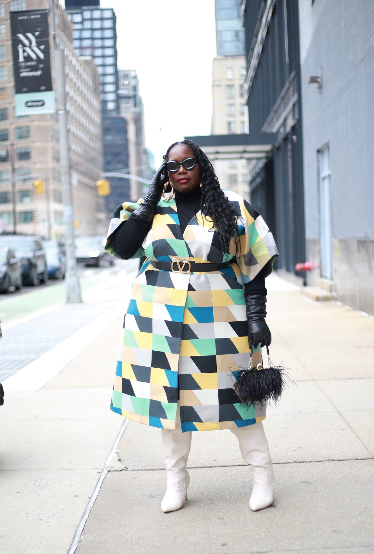 New York Fashion Week Outfits featuring plus size blogger Stylish curves in a colorful checkered coat with white boots and black leather gloves, black sunglasses, and a feather bag
