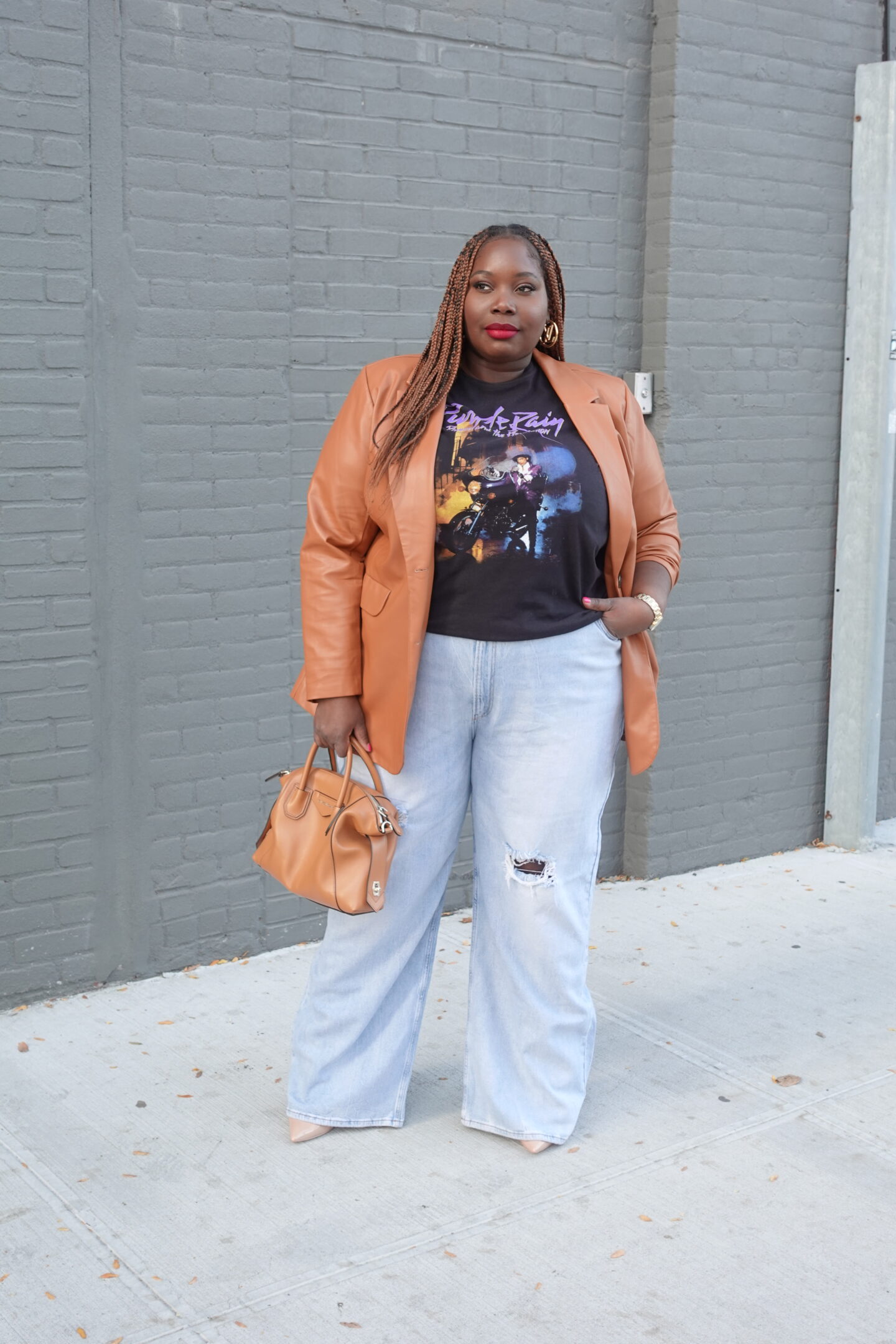Plus size wide leg jeans outfit with graphic tee and leather blazer