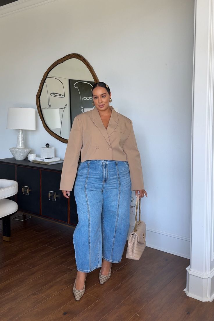 business casual outfit of barrel leg jeans and a blazer on a plus size woman